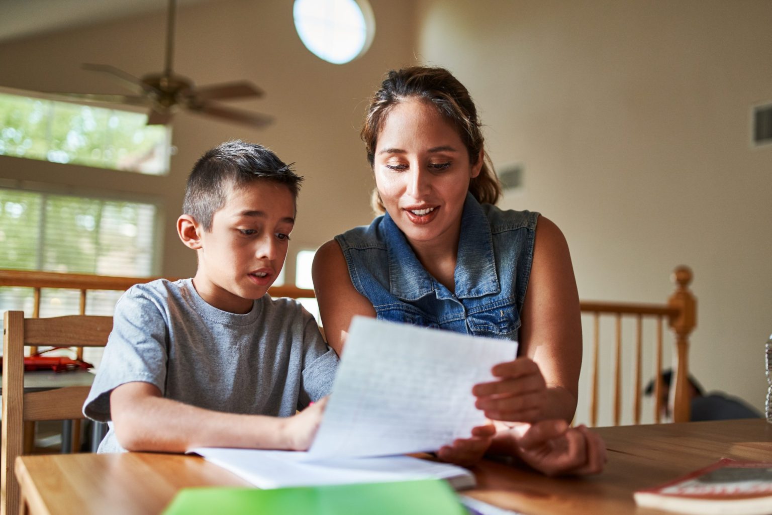 mother helping son with homework